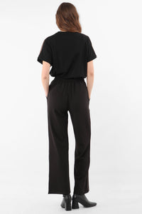 black wearable trouser with copper glitter stripe down the side seam.  Elasticated waist in soft fabric.  Plain back with no pockets.