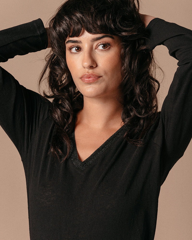 The Lewis is a long-sleeved, V-neck black T-shirt with a ribbed neckline finished in iridescent lurex. Glamourous yet relaxed style, wear smart or casual.