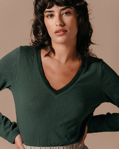 The Lewis is a long-sleeved, V-neck dark green T-shirt with a ribbed neckline finished in iridescent lurex. Glamourous yet relaxed style, wear smart or casual.