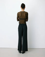 Load image into Gallery viewer, Noblesse fluid, straight, wide leg, black trousers with an elasticated waistband and front italian pockets.  Simple, relaxed style, smart and casual.  Woman's silhouette shown from the back.
