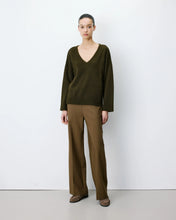 Load image into Gallery viewer, The Grace and Mila Salvador khaki jumper, crafted from a subtle lurex knit, it has the softest shimmer giving it a certain elegance. It has a relaxed fit, long sleeves, v-neckline and small side slits with ribbed finished cuffs.  Simple yet stylish, easy to wear and a classic for your wardrobe.