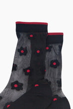 Load image into Gallery viewer, A pair of delicate black sheer socks with pretty black daisy design with red centre and red trim at ankle! Lightweight and breathable, they offer a comfortable, weightless fit for all-day elegance.