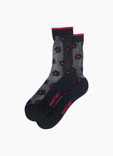 Load image into Gallery viewer, A pair of delicate black sheer socks with pretty black daisy design with red centre and red trim at ankle! Lightweight and breathable, they offer a comfortable, weightless fit for all-day elegance.